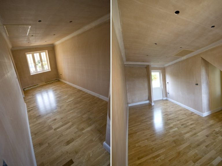 Empty room with wooden flooring and light-coloured walls, featuring a window.
